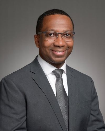 Picture of Walter Conwell, MD wearing glasses and smiling in a gray suit with a gray tie.